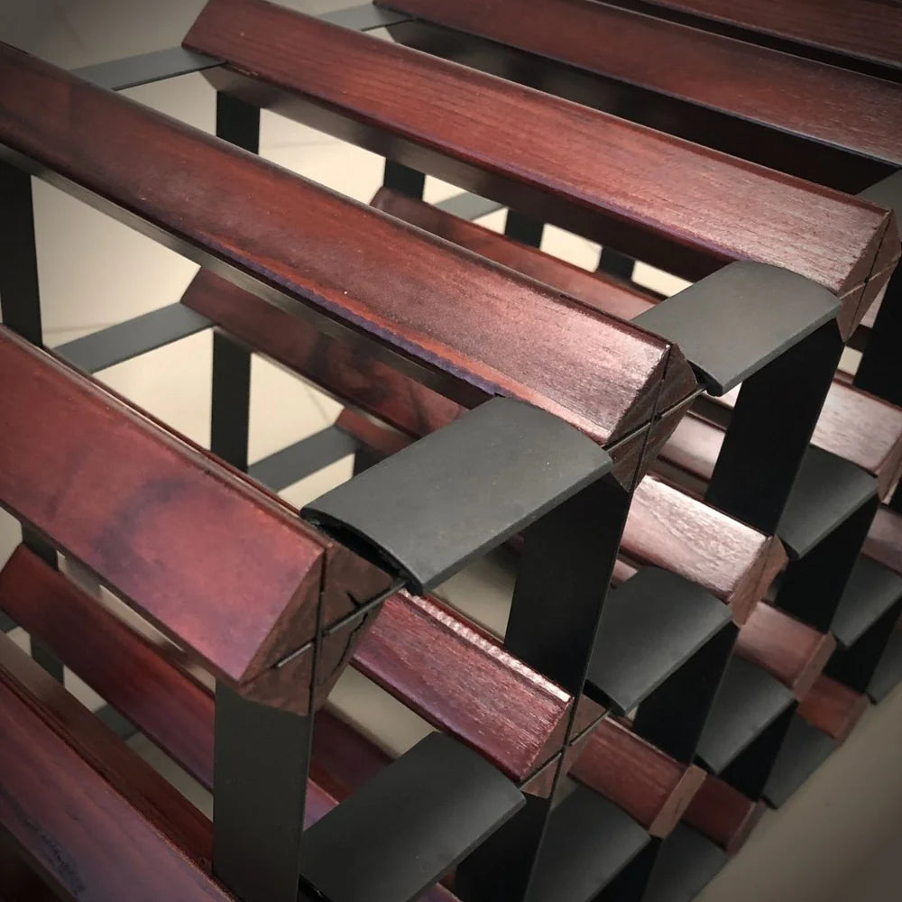 Close-up of a wooden and metal staircase with a geometric design.