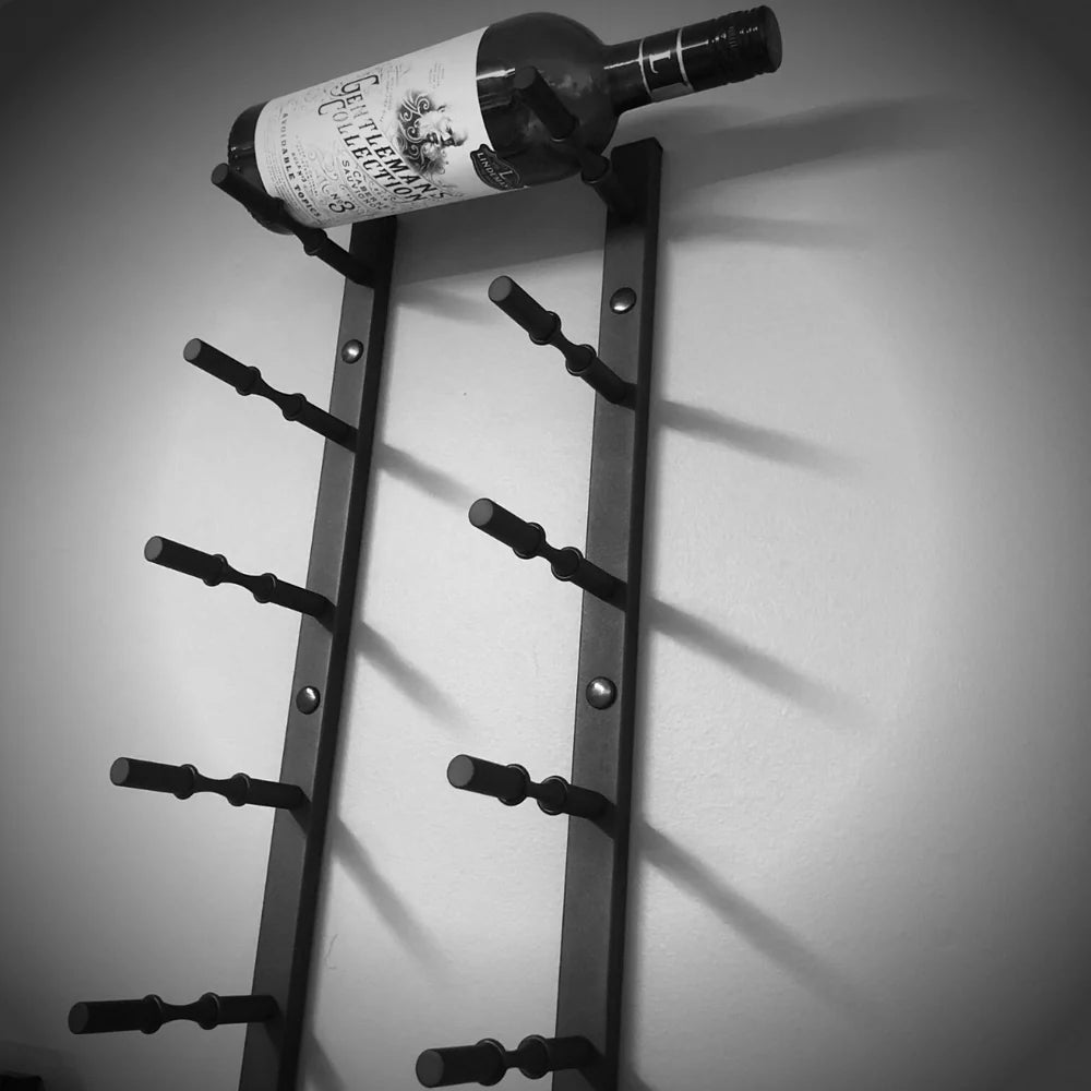 Wall-mounted wine rack holding a bottle against a gray background
