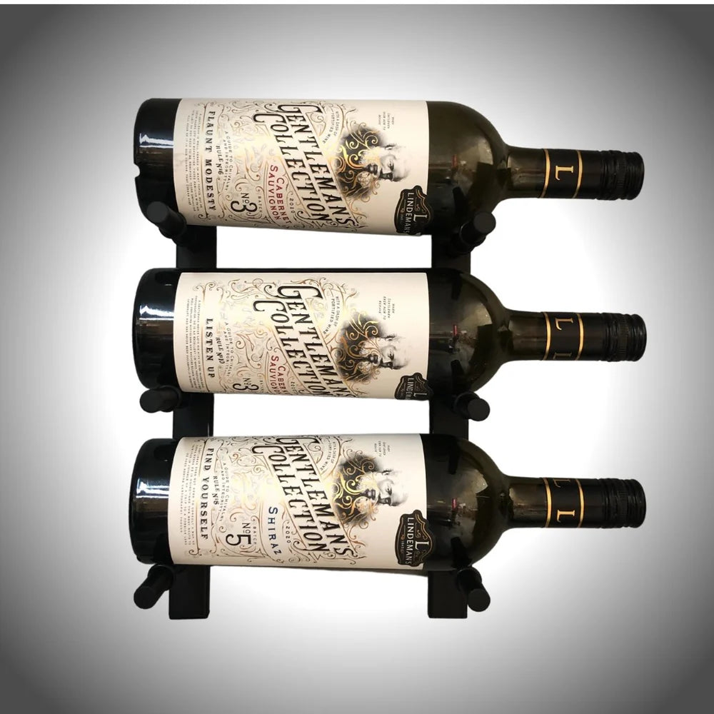 Three bottles of wine with labels on a gray background