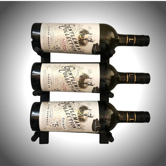 Three bottles of wine with labels on a gray background
